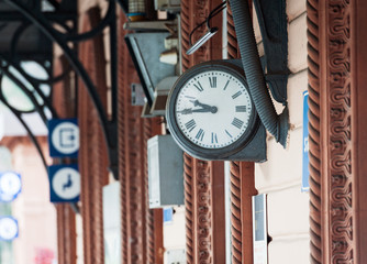 Fototapeta na wymiar Old vintage clock at rail station wall of Varenna town, Lombardy, Italy