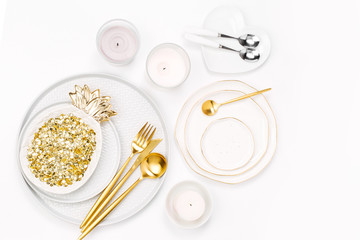 Tableware and decorations for serving a festive table.  Plates, wine glasses and cutlery with  candles  on white background.