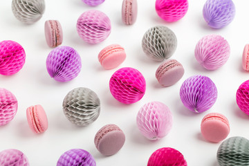 Stylish background with macaroons and lilac honeycomb balls with copy space for text. isolated on white background.