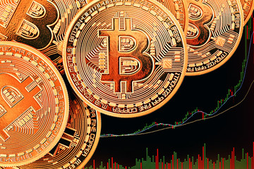 Golden Bitcoins on a gold background .Photo (new virtual money ) New crypto currency in the form of the coins. 