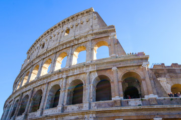 Fototapeta premium Colosseum Rome. Ruins of the ancient Roman amphitheatre. Travel to Italy, Europe. Crowd and queue. Sunny day and blue sky
