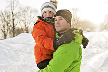 Fototapeta na wymiar Father And Son In Snowy Landscape