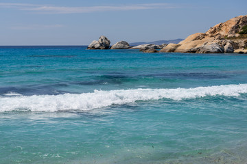 Fototapeta na wymiar Sea with with shallow crystal clear sea water, Mikri Vigla beach on Naxos island, Greece