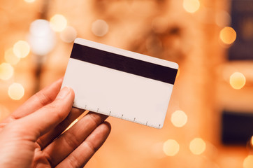 in his hand a money card. bokeh.