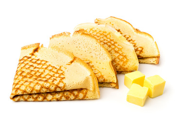 A pancake folded in a triangle and butter on a white, isolated.