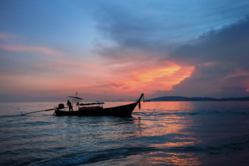 fishing boat on the background of a colorful beautiful sunset. Krabi. Thailand. Paradise rest. Relaxation