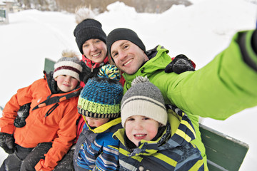 family and child spending time outdoor in winter