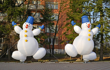 Two cheerful inflatable snowmen. Christmas decoration on the street of Zelenogradsk, the...