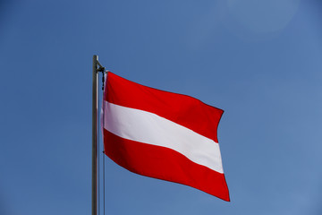 Fototapeta na wymiar National flag of Austria on a flagpole