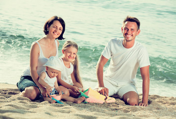 Fototapeta premium happy family of four at beach.