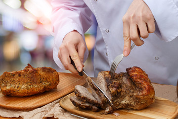 Cook slices a bigger piece of meat .