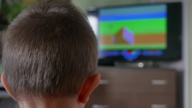 European white boy playing the computer game video console motorcycle races