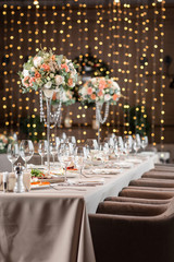 Decorated table in the restaurant, the preparation before the banquet. the work of professional florists.
