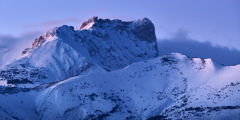 Bure Peak (Pic de Bure) in the Devoluy Mountain range at dusk in Winter. Hautes-Alpes, French Alps,...