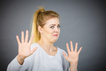 Scared woman gesturing stop gesture with hands