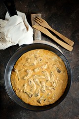 Classic beef Stroganoff in white sauce in a cast-iron frying pan.