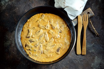 Classic beef Stroganoff in white sauce in a cast-iron frying pan.