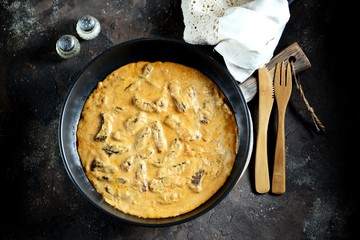Classic beef Stroganoff in white sauce in a cast-iron frying pan.