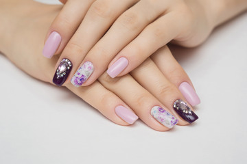 Manicured nails Nail Polish art design. Violet with green colors Art Manicure. Nail Polish. Beauty hands. Fashion Stylish Trendy Colorful Nails