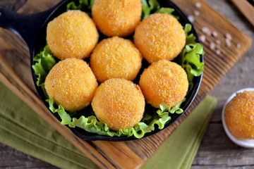 Potato croquettes and yogurt sauce with green onions. Fast food.
