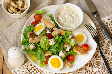 Caesar salad with lettuce, grilled chicken and vegetables