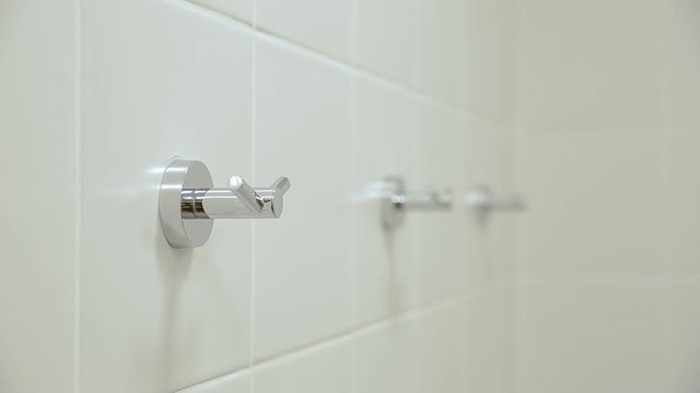Three towel racks in shower cabin with ceramic tile 