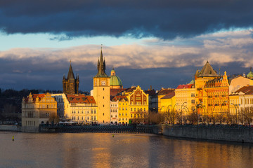 Beautiful night view of the Charles Bridge, the Old Town Bridge Tower, and the Old Water Tower, the Smetana Embankment and the Prague Beer Museum in Czech Republic New Year's Eve