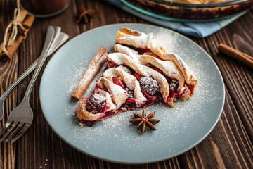 Delicious homemade pie with berries on a wooden background