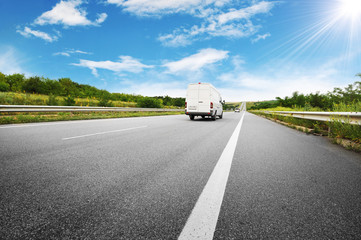 Big van on the countryside road shipping fuel against sky