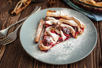 Delicious homemade pie with berries on a wooden background