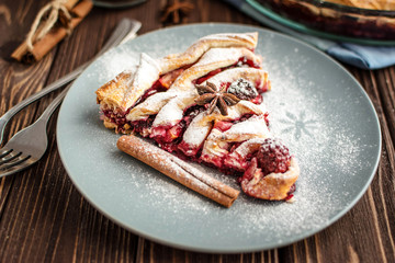 Delicious homemade pie with berries on a wooden background