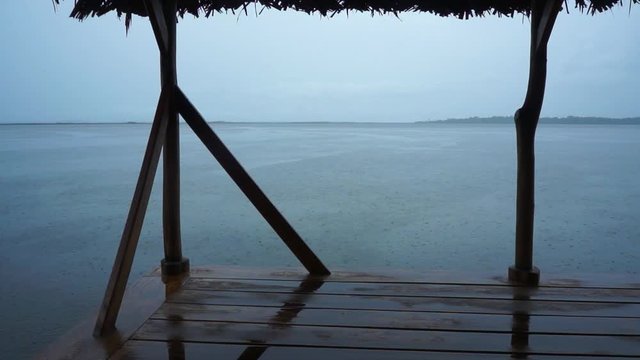 Cloudy weather with rain on calm sea and islands in background, Caribbean sea, Panama, Central America, 50fps.