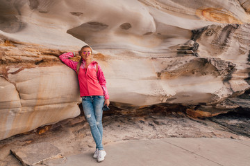 Young girl hiking around the Bondi beach in Sydney during windy weather.
