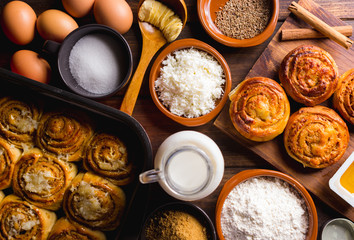 Table full of ingredients for the preparation of cinnamon rolls with cheese. golfeados desserts typical in Venezuela.
