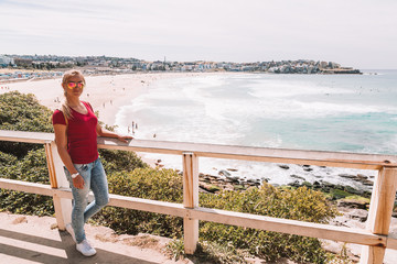 Young girl hiking around the Bondi beach in Sydney during windy weather.