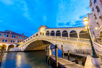 Venice, Italy. Rialto bridge and Grand Canal at twilight blue hour sunrise. Tourism and travel concept.