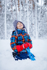 Fototapeta na wymiar Beautiful young boy in winter park