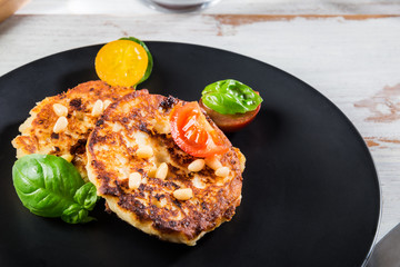 Ricotta pancakes with spinach, tomatoes, basil and pine nuts sal