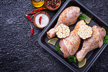 Raw chicken legs with spices ready for cooking