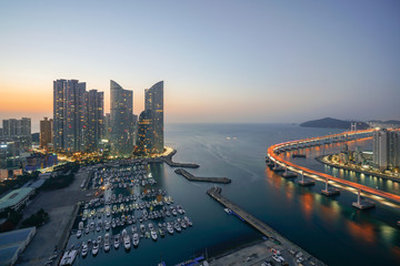 Fototapeta na wymiar Busan city skyline view at Haeundae district, Gwangalli Beach with yacht pier at Busan, South Korea.