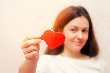 young brunette girl giving heart, valentine's day