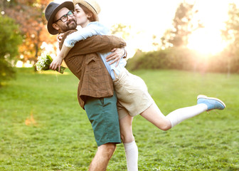 couple in love in nature hugging with flowers on St. Valentine's Day