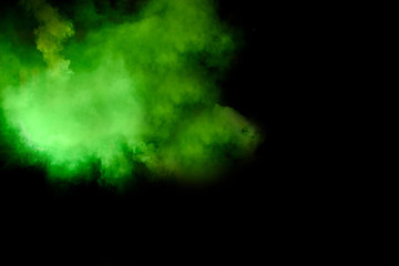 Obraz na płótnie Canvas Colorful green smoky isolated on black background. Smoke bomb is pyrotechnic means for starting to fog, designed to supply signals that indicate pick-up masking of objects (including riots). 