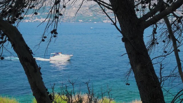 Bay at Lovrecina beach on island Brac, Croatia. Summer vacation. Speedboat passing by. Editorial use only!