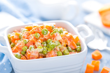Green peas stewed with carrots in creamy milk white sauce, vegetable stew