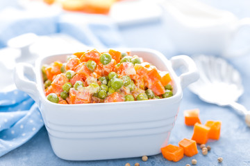 Green peas stewed with carrots in creamy milk white sauce, vegetable stew