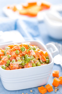 Green peas stewed with carrots in creamy milk white sauce, vegetable stew