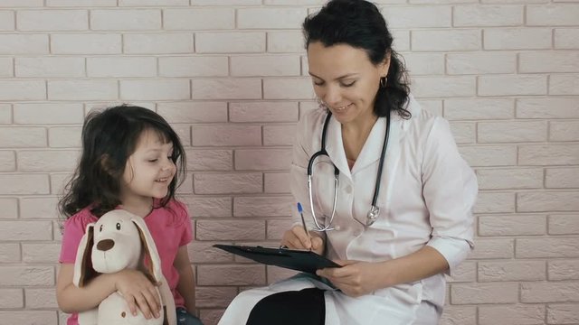 Pediatrician with a child. Little girl at the doctor.