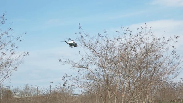 a tracking shot of a marine corp helicopter, of the type used to transport the president of the united states, near the pentagon in washington, d.c.