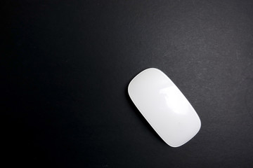 White mouse over a black background.